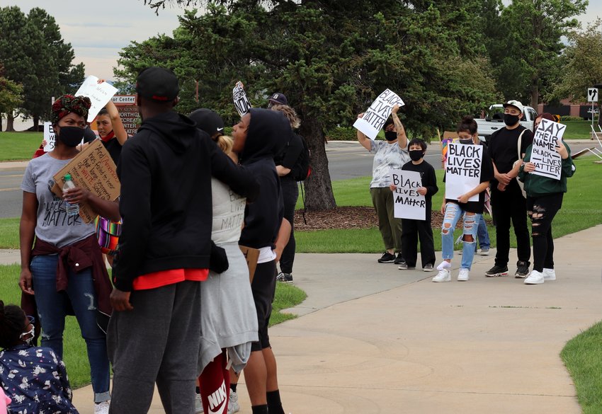Protesters, standing in clusters to maintain social distancing, have a 10 minute moment of silence at the end of June 6 protest for racial justice in Northglenn's E.B. Rains Park. The protest began in the park and proceeded along Community Center Drive to the city's Justice Center, home for the Northglenn Police and back.